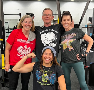 Results Only Fitness members and coach smiling together inside the gym after a training session.