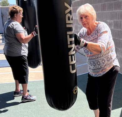 Older adults participating in a senior fitness boxing workout at Results Only Fitness.